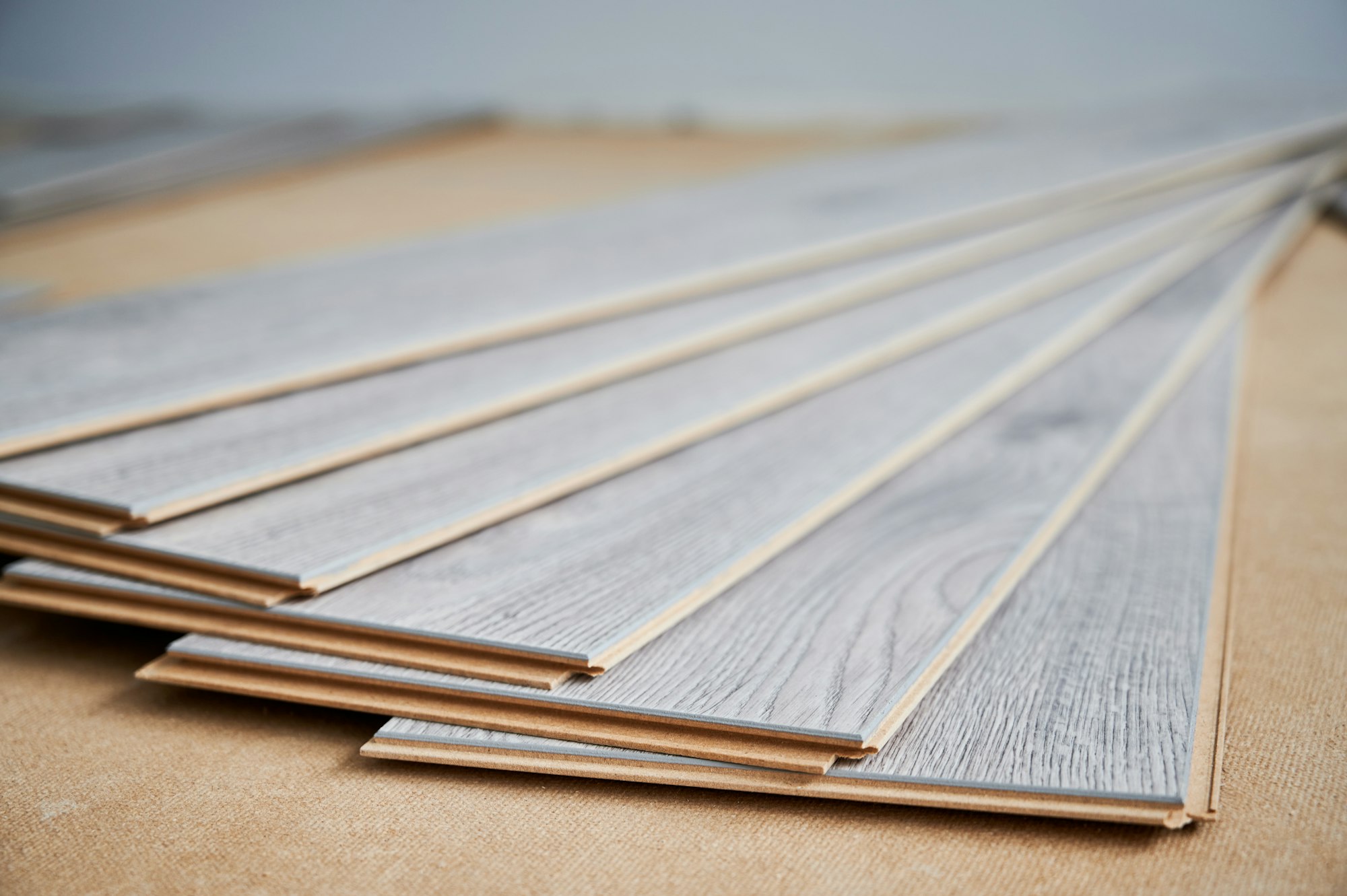 Samples of laminate timber planks on the floor.